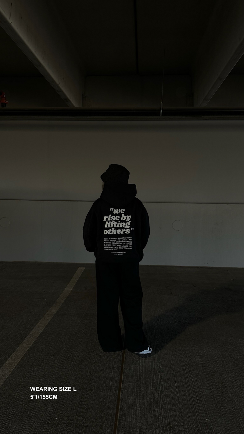 WE RISE BY LIFTING OTHERS HOODIE - BLACK